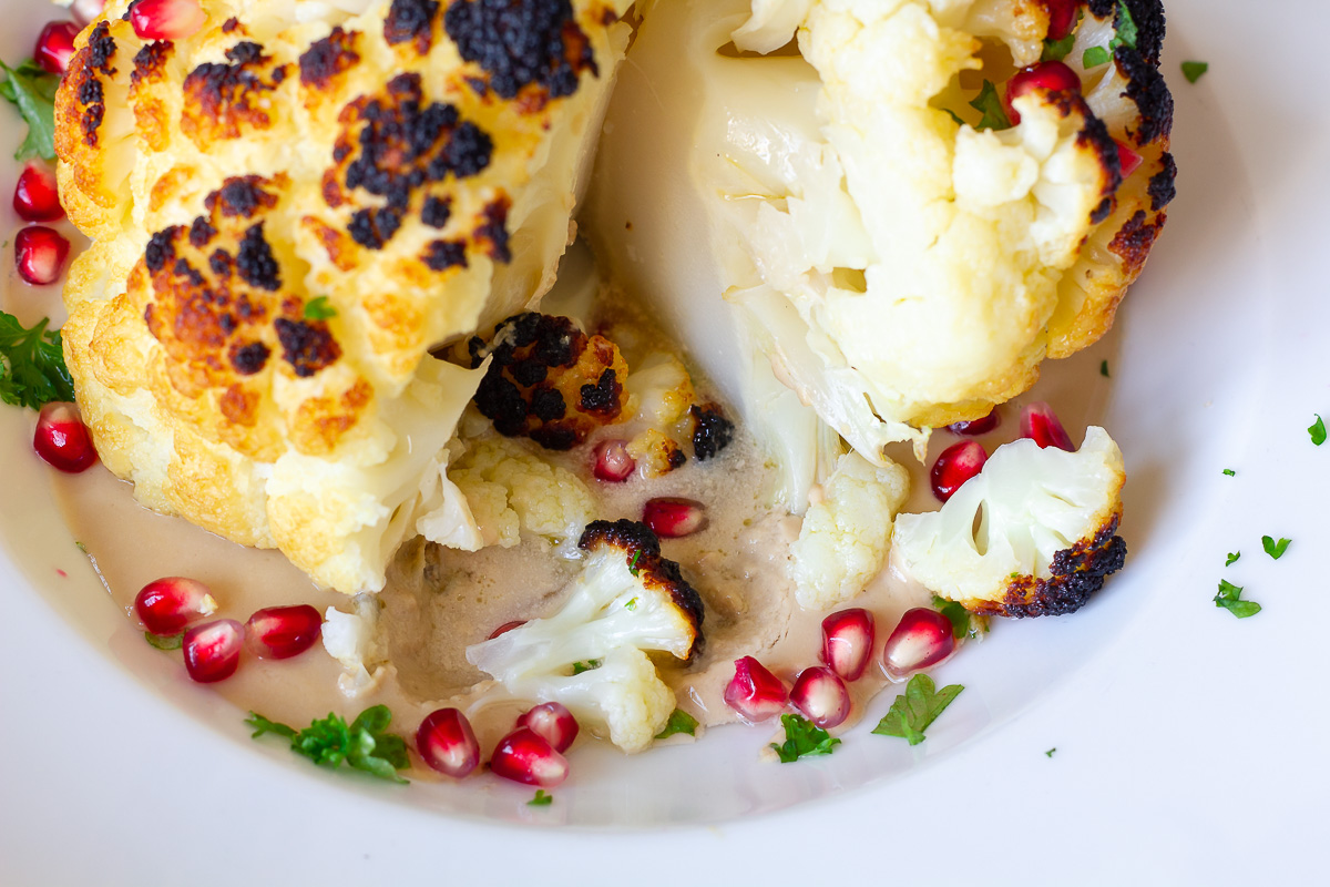 Whole Roasted Cauliflower with Pomegranate Tahini Sauce